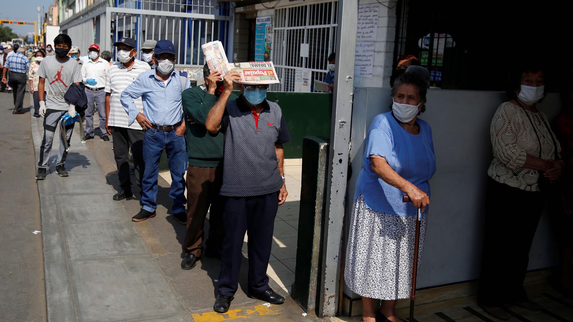 People wait outside Lima's central market as Peru extended a nationwide lockdown amid the outbreak of the coronavirus disease (COVID-19), May 8, 2020. 