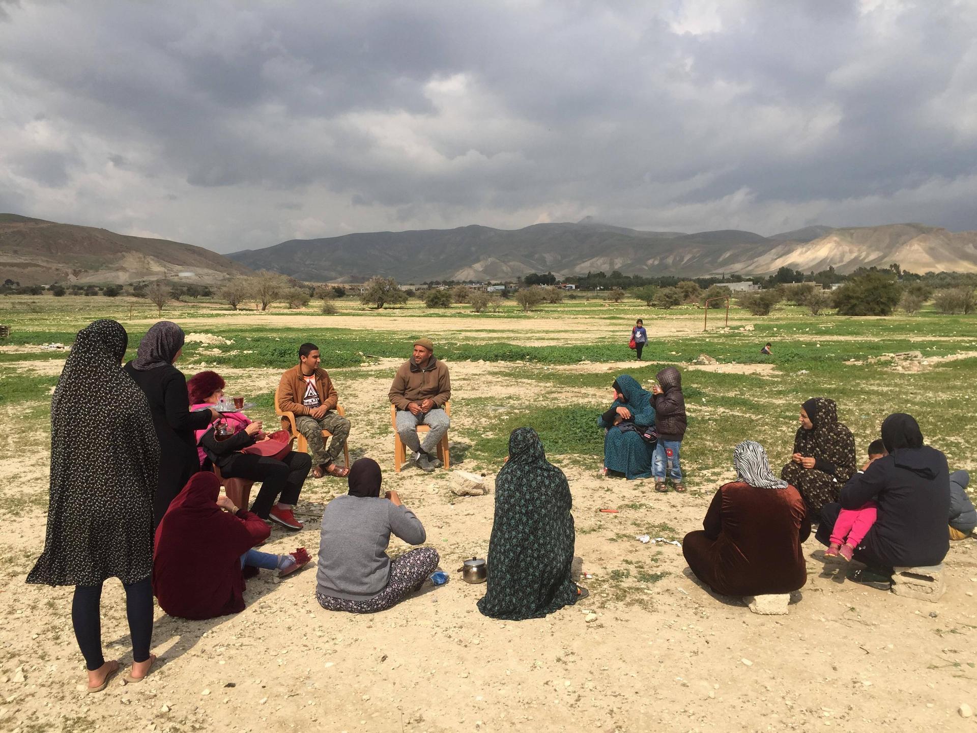 Palestinian residents of the village of Fasayil in the Jordan Valley sit together for an afternoon tea break.