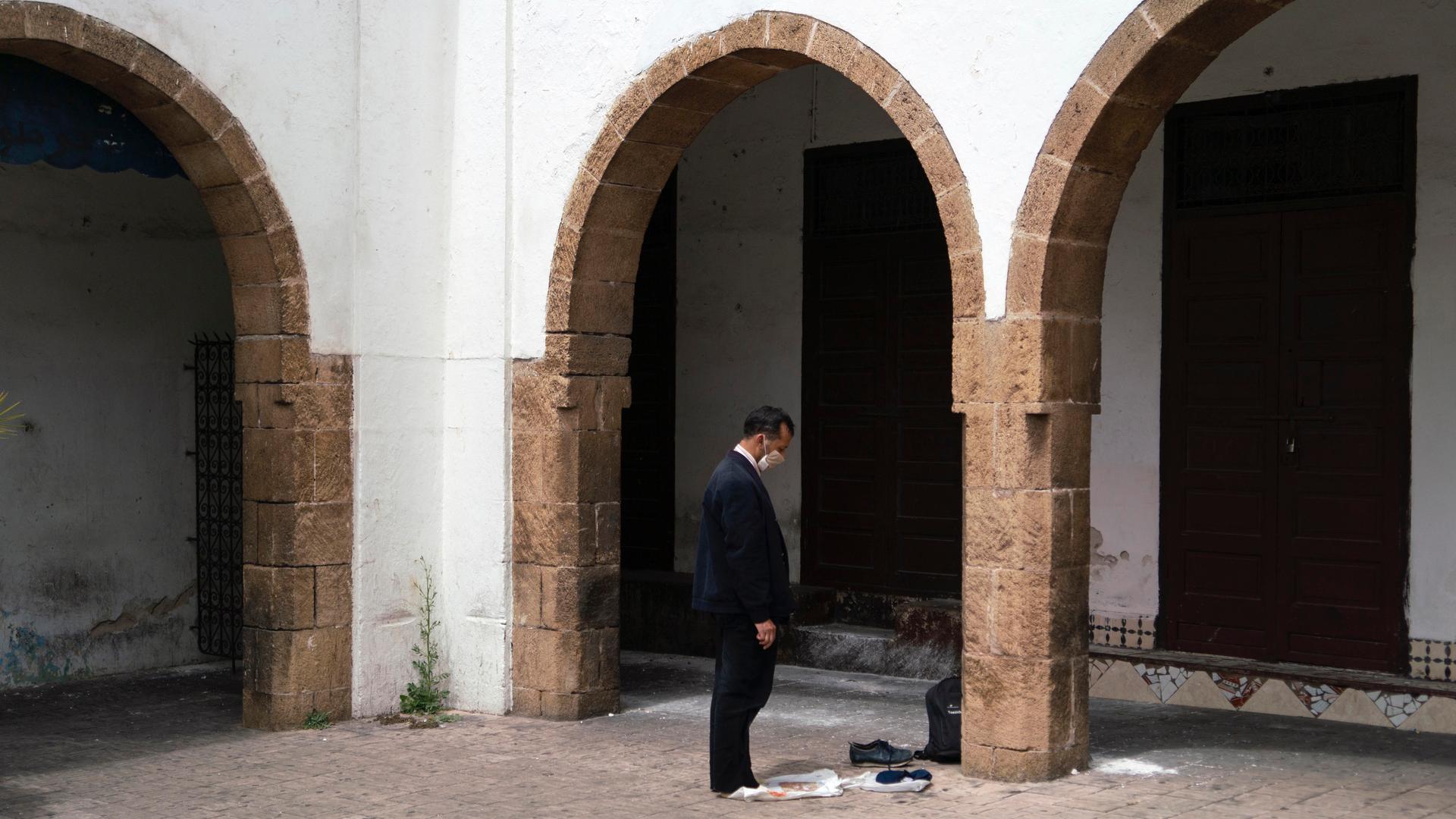 A man prays in the deserted Habbous neighborhood of Casablanca.
