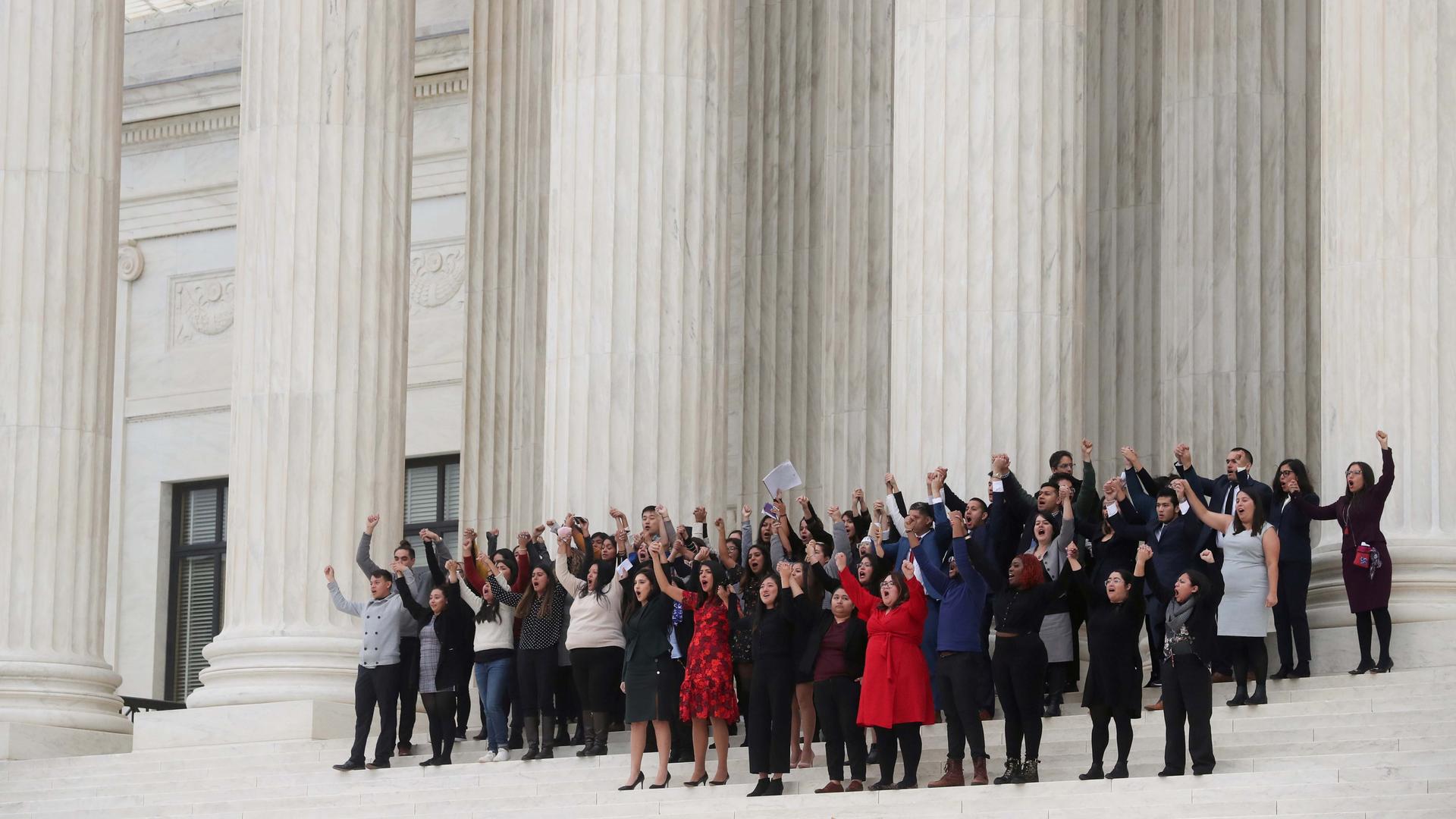 DACA plaintiffs walk arm-in-arm down from the US Supreme Court after justices heard oral arguments in the consolidation of three cases before the court regarding the Trump administration’s bid to end the DACA program on Nov. 12, 2019.