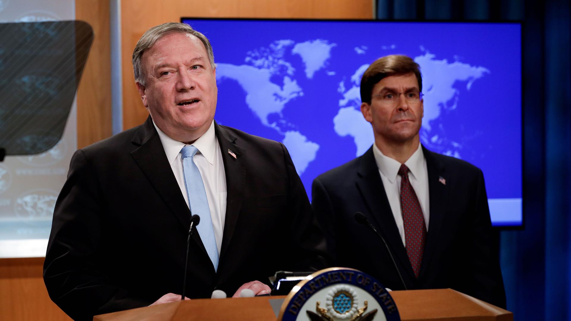 US Secretary of State Mike Pompeo speaks about a Trump administration executive order on the International Criminal Court as Defense Secretary Mark Esper listens during a joint news conference at the State Department in Washington, June 11, 2020. 