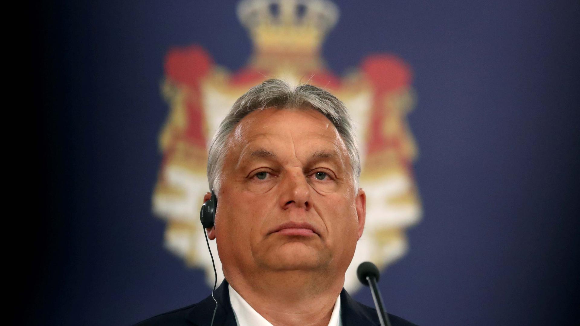 A close-up photo of Hungarian Prime Minister Viktor Orban wearing headphones