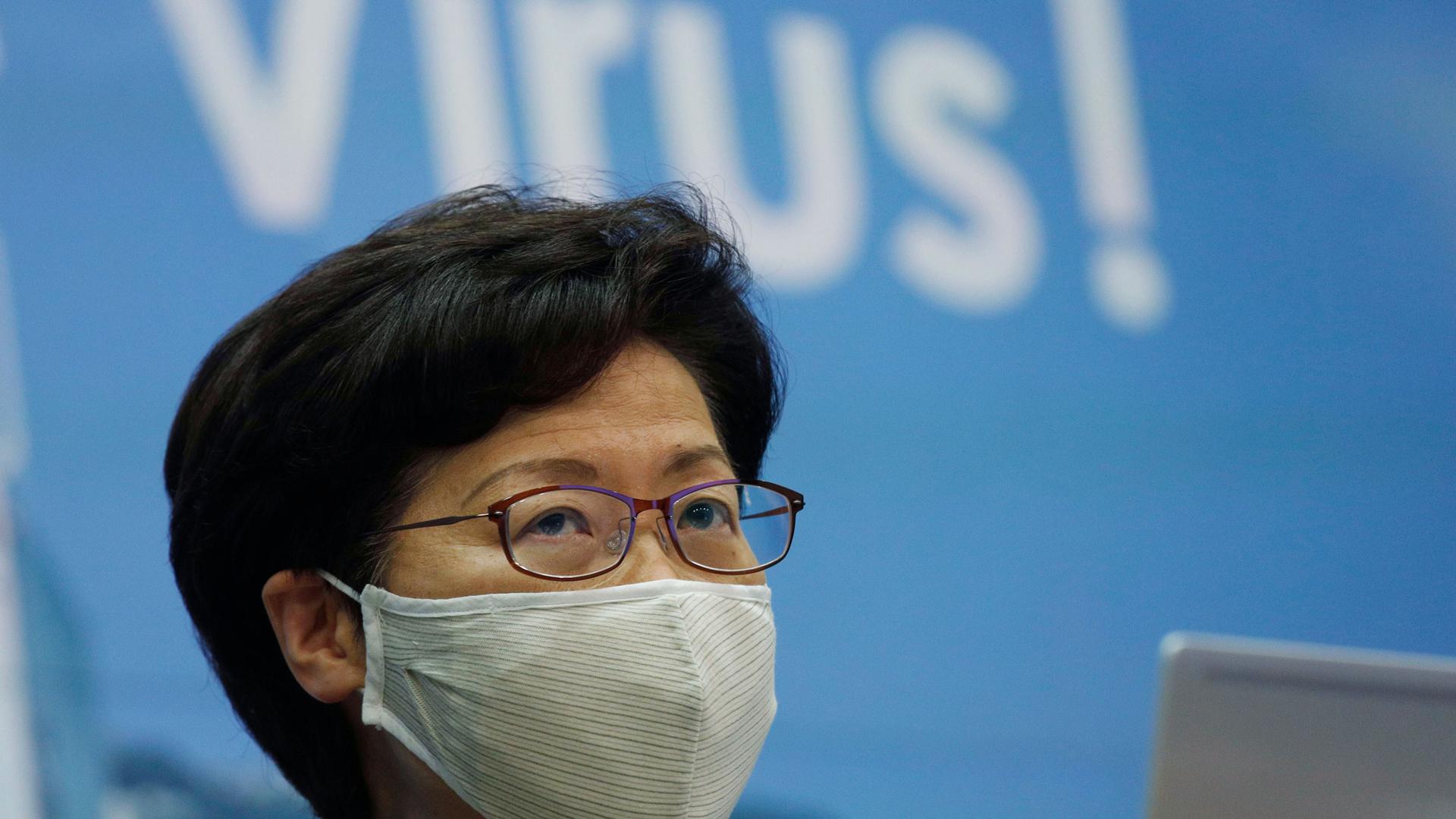 A close-up photograph of Hong Kong Chief Executive Carrie Lam who is shown wearing a face mask and glasses.