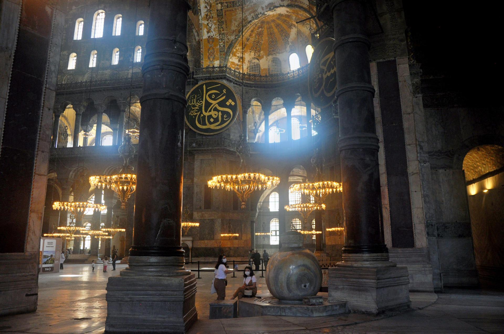 Tourists take in the ornate beauty of the Haghia Sophia dome