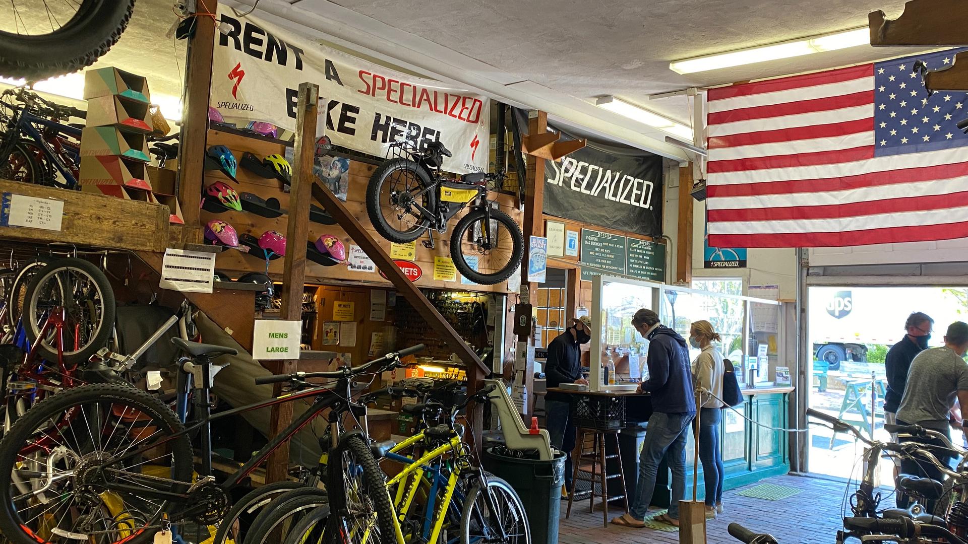 Inside of a bike shop with a large American flag in sunlight 