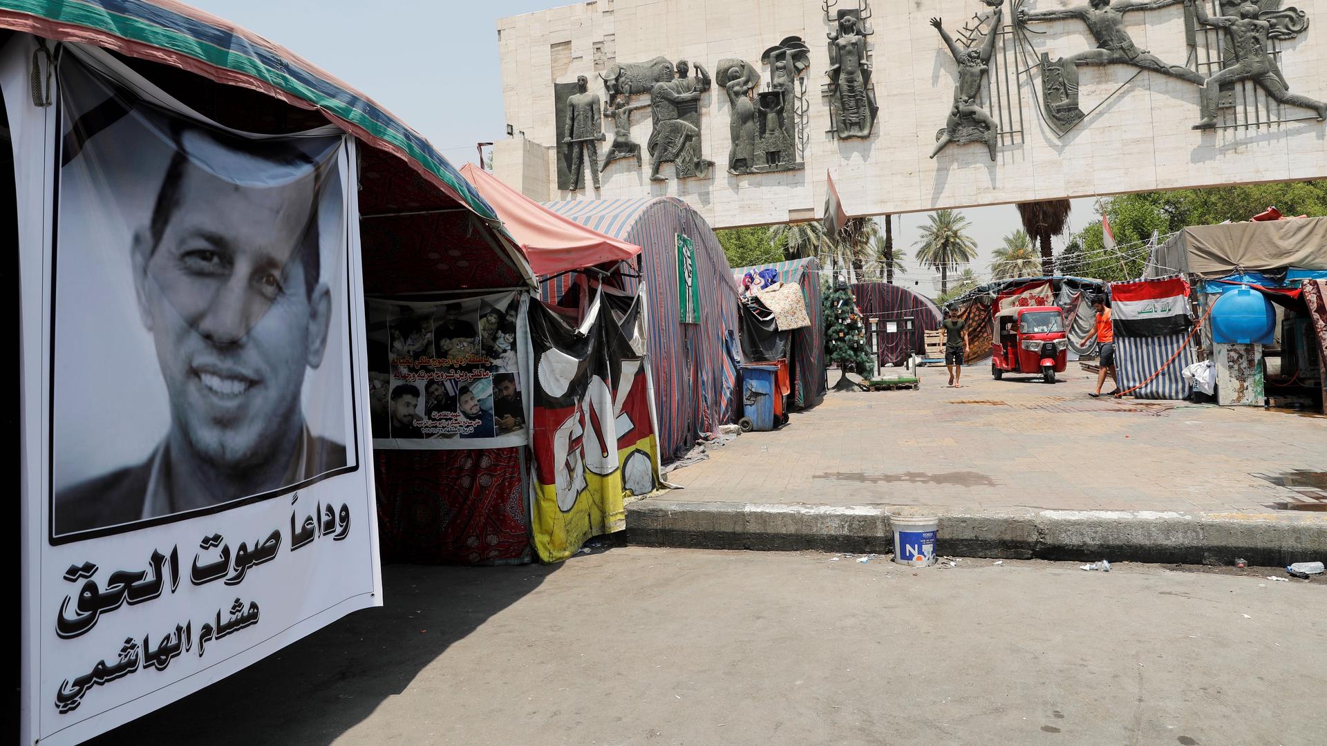 A poster depicting the former government adviser and political analyst Husham al-Hashimi, who was killed by gunmen, is seen in Tahrir Square in Baghdad, July 8, 2020. 