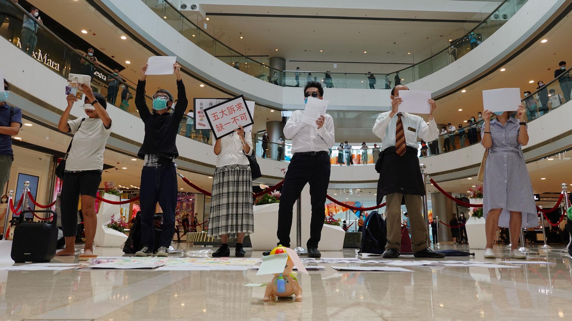 Pro-democracy demonstrators take part in a lunchtime protest against the national security law, at a shopping mall in Hong Kong, July 6, 2020. 