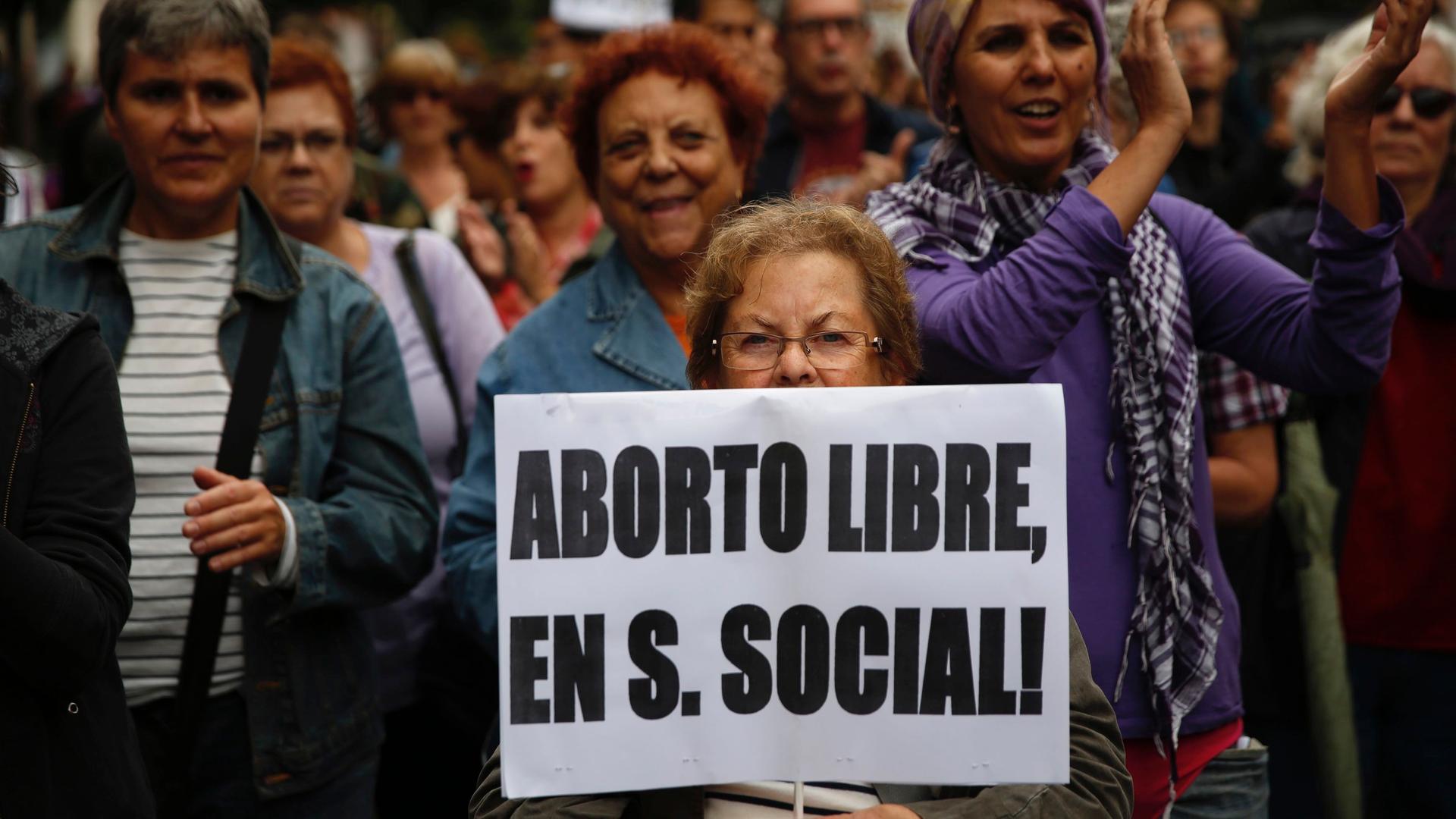 A woman holds a banner that reads "Free abortion covered by social security" during a pro-choice march to celebrate the government ending its plan to reform Spain's abortion law in Madrid September 28, 2014. Spanish Prime Minister Mariano Rajoy on Tuesday