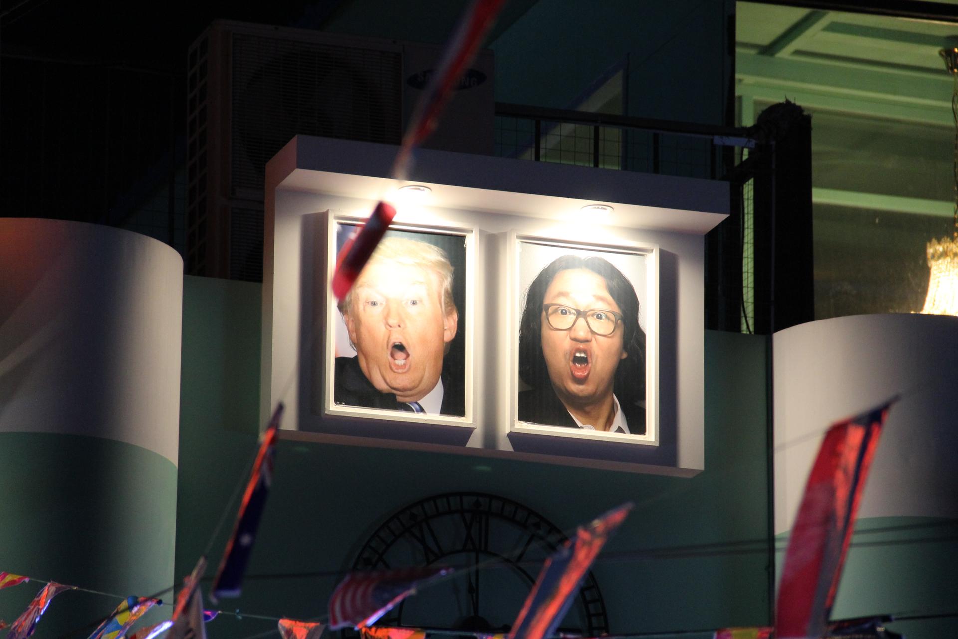 Caricaturelike portraits of United States President Donald Trump and South Korean comedian Kim Gyeong-jin are displayed outside the pub.
