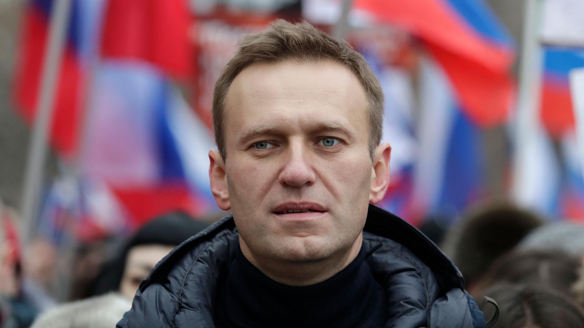 A close-up photograph of Alexei Navalny wearing a dark puffy jacket.