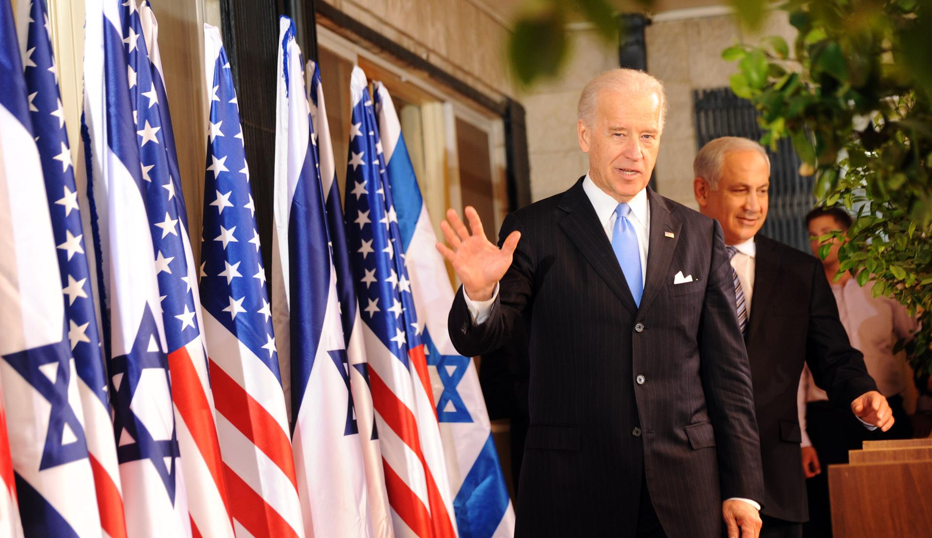 VP Joe Biden with Israeli PM Benjamin Netanyahu on a stage with US and Israeli flags