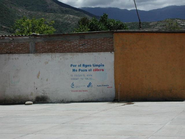 A stenciled message displayed on a concrete wall
