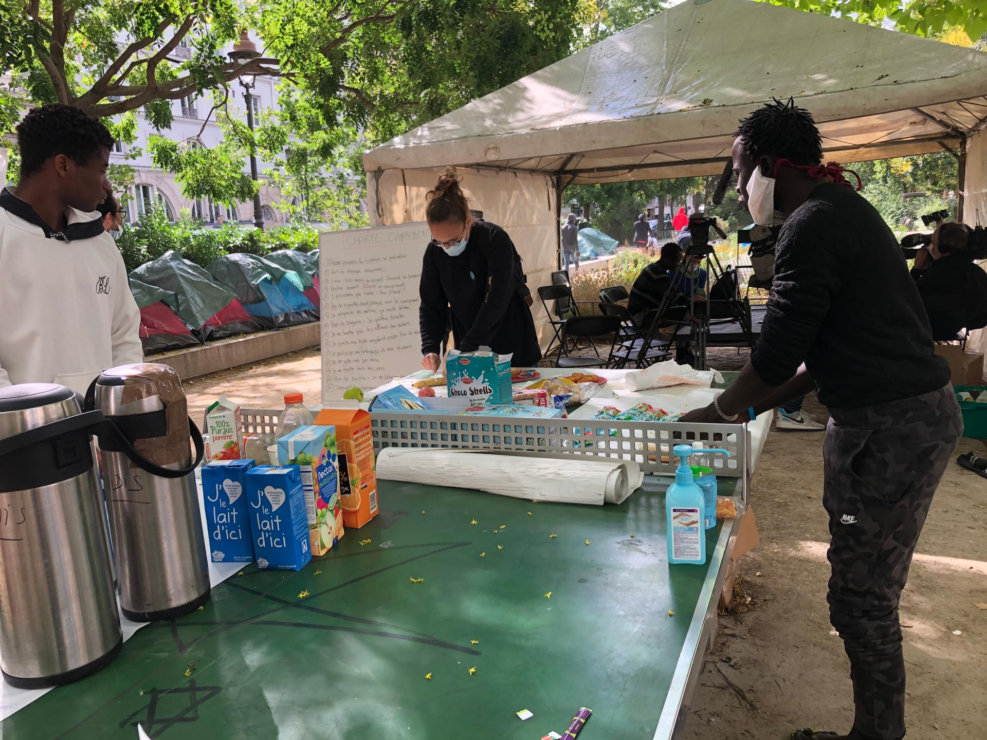 The temporary camp for 100 migrants in Paris was set up by five nongovernmental organizations who are trying to help the boys find permanent housing. Here, breakfast was being served to the boys.