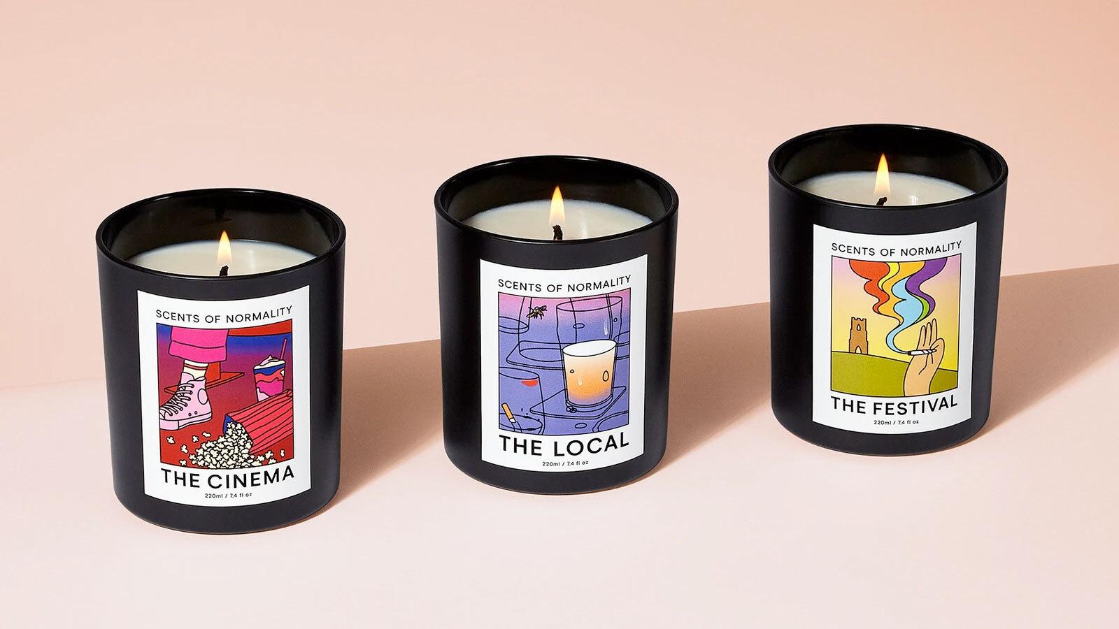 Three candle jars with colorful labels