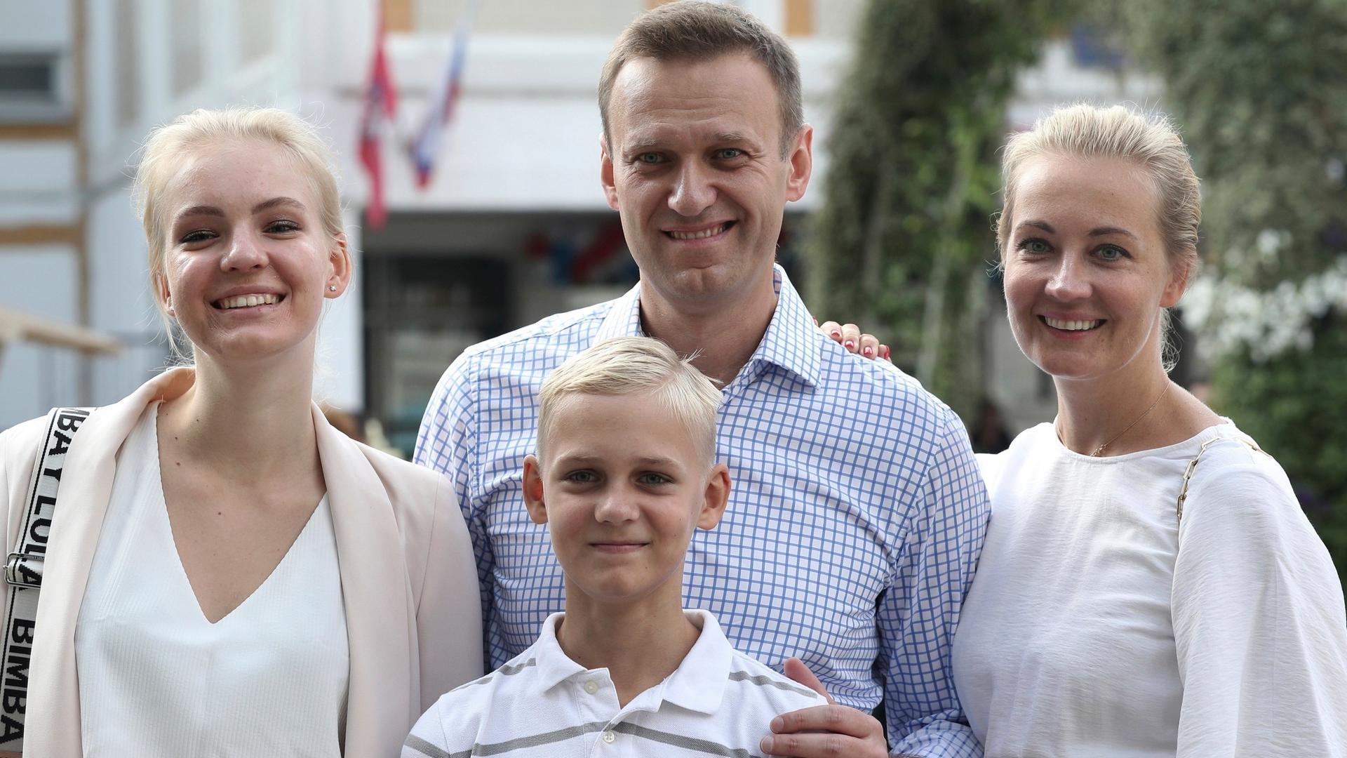 Russian opposition leader Alexei Navalny, with his wife Yulia, right, daughter Daria, and son Zakhar pose for the media after voting during a city council election in Moscow, Russia.
