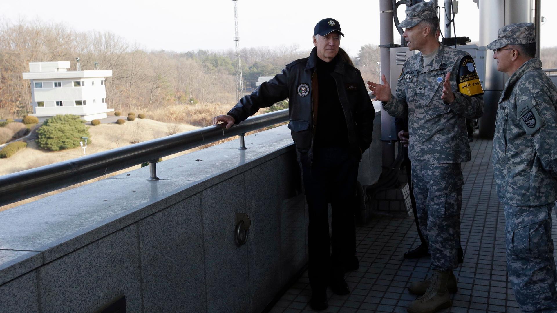 In this file photo from Dec. 7, 2013, US Vice President Joe Biden listens to Colonel James Minnich, Secretary of the United Nations Command, Military Armistice Commission, at the border village of Panmunjom, in the Demilitarized Zone (DMZ), the military b