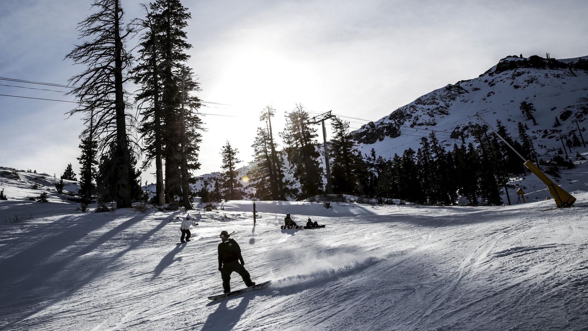 A snowboarder heads back to the lodge at Squaw Valley in Olympic Valley, California, Dec. 5, 2015. Last month, the resort announced plans to change its name in the coming year.