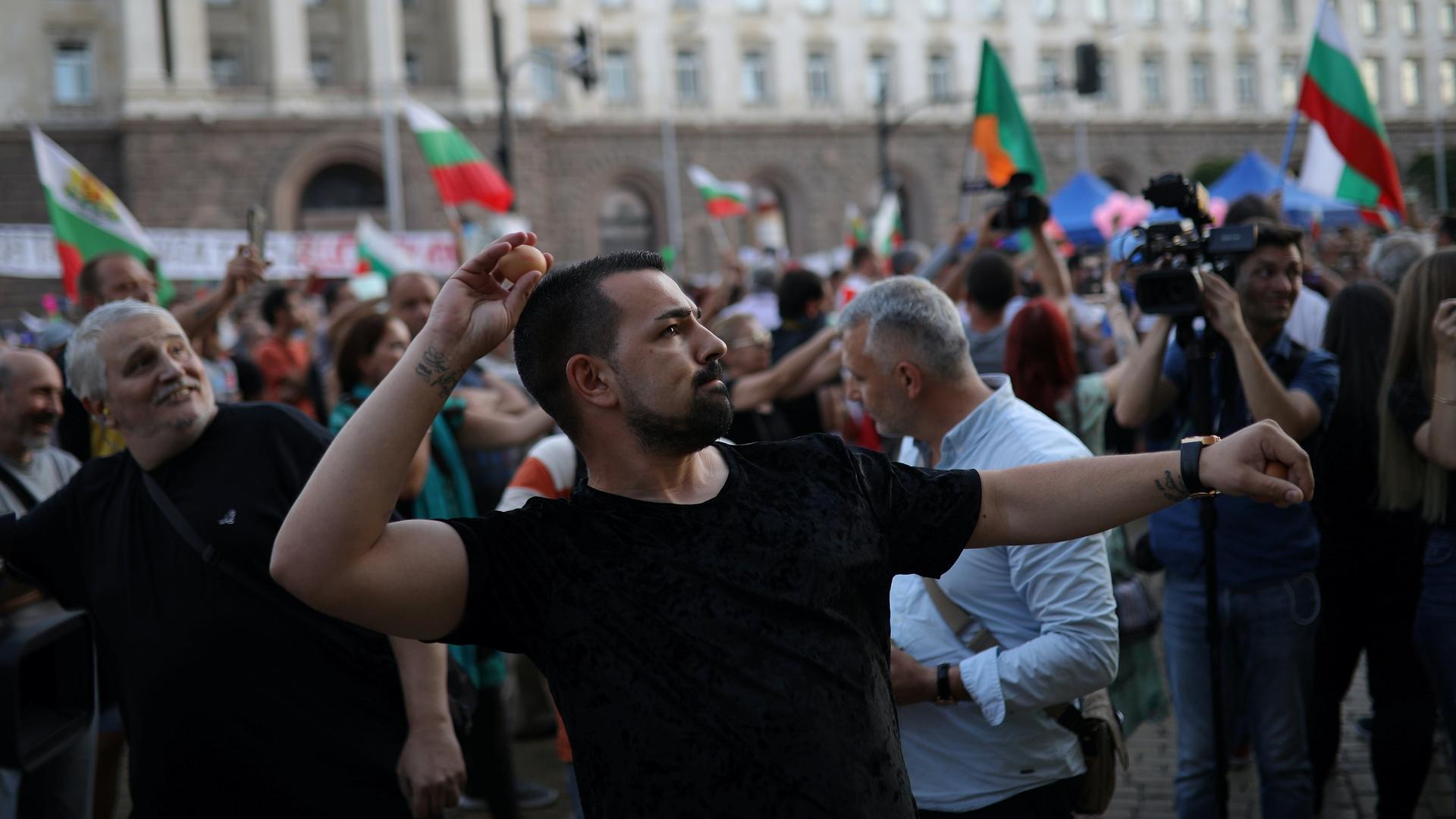 A protester throws an egg at the Bulgarian government building during an anti-government demonstration. 