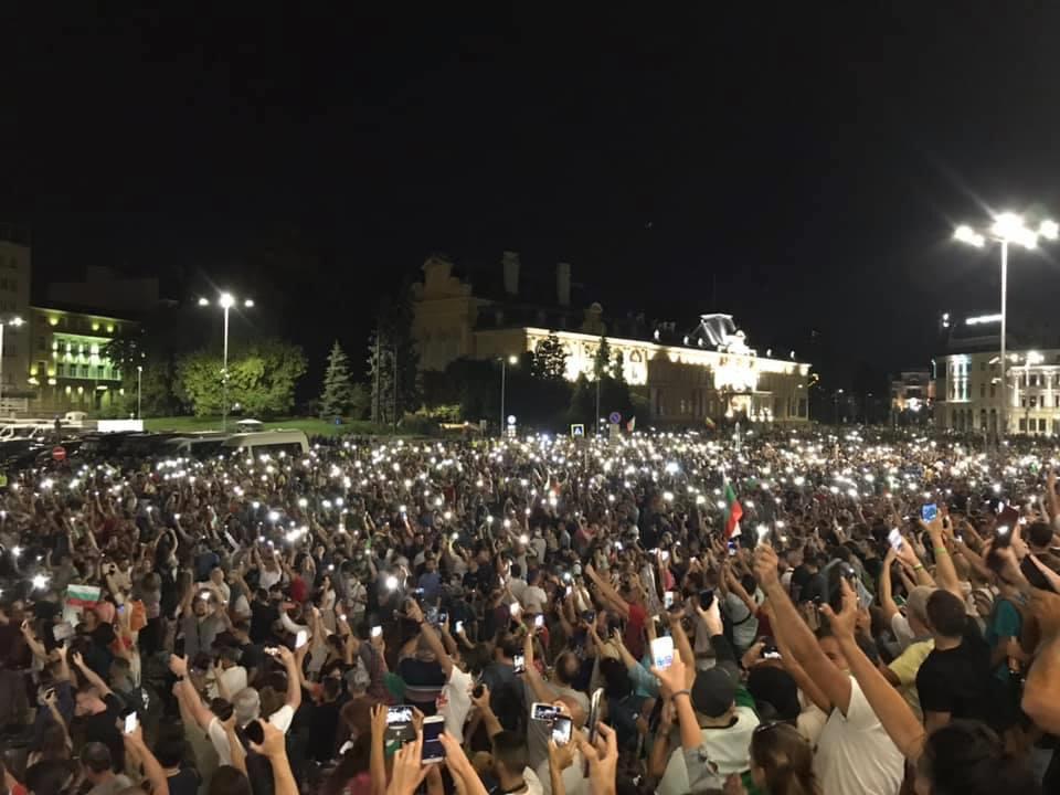 Mass crowds hold lights in a protest outside in Sofia, Bulgaria