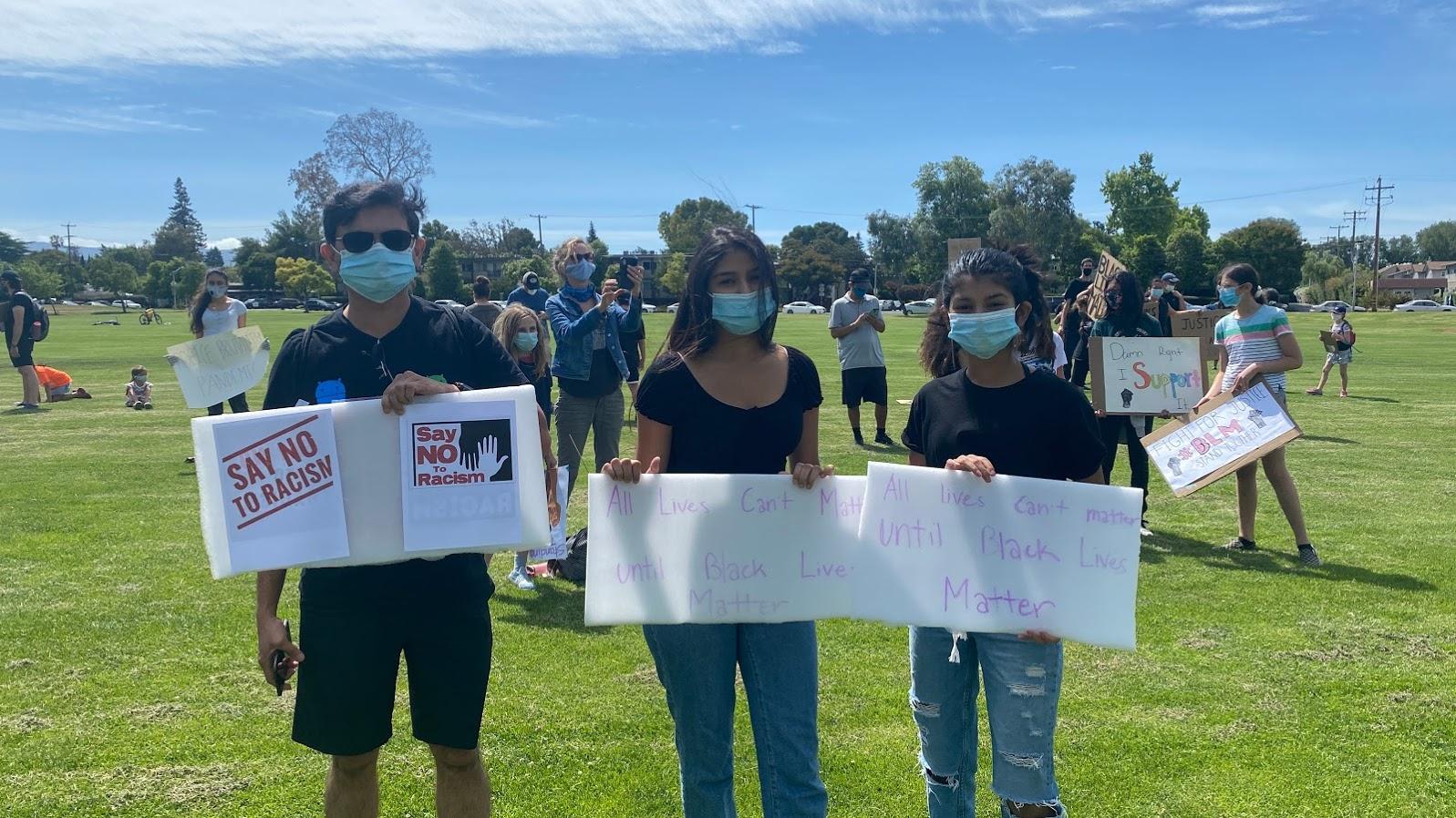 Nilesh Junnarkar, left, Esha Junnarkar, center, and Anushka Junnarkar take part in a racial justice protest organized by Indian American groups in Palo Alto, California, on June 5, 2020.