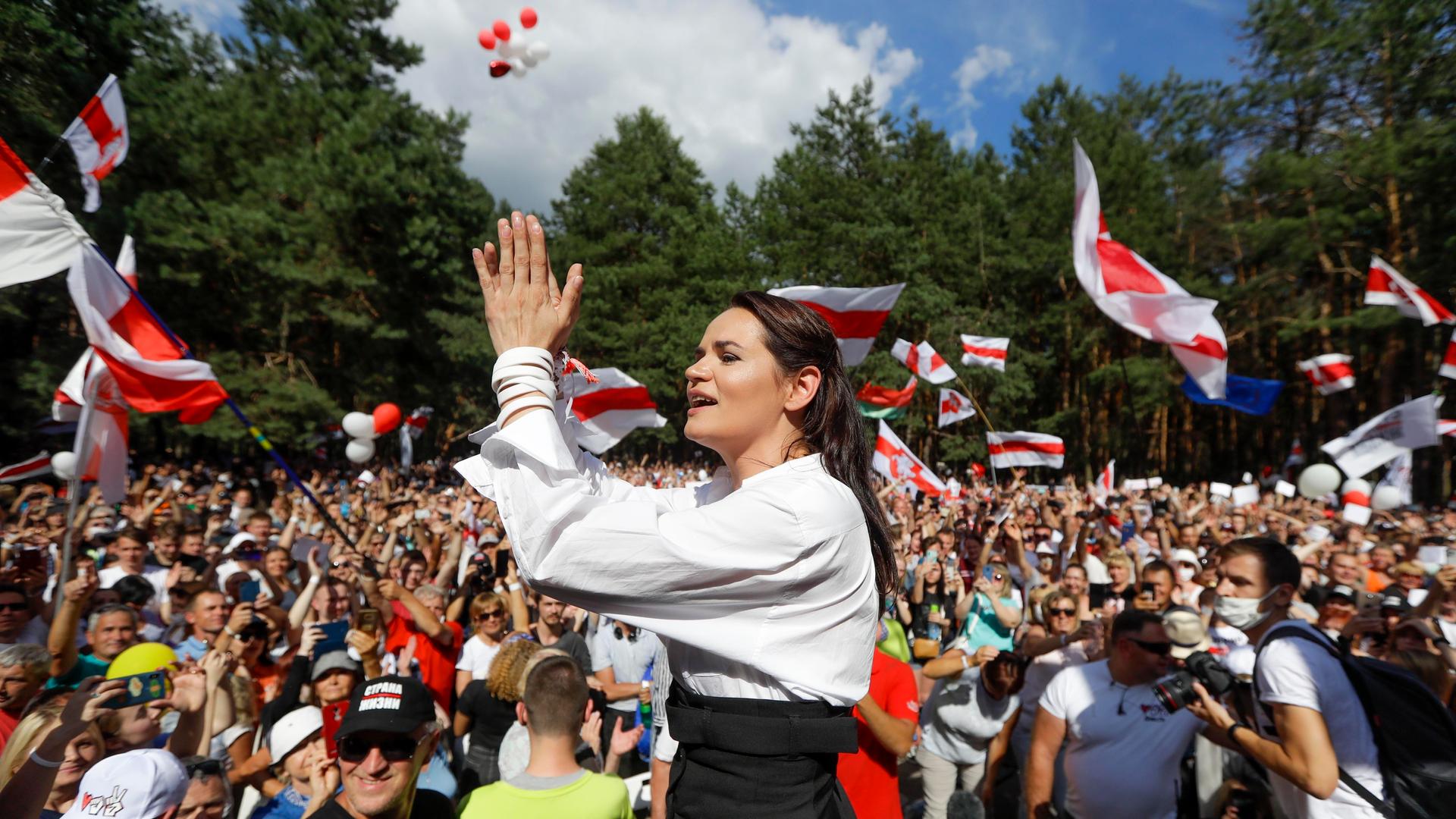 Svetlana Tikhanovskaya, a candidate for the presidential elections in Belarus, greets people during a meeting in her support in Brest, Belarus, Aug. 2, 2020.