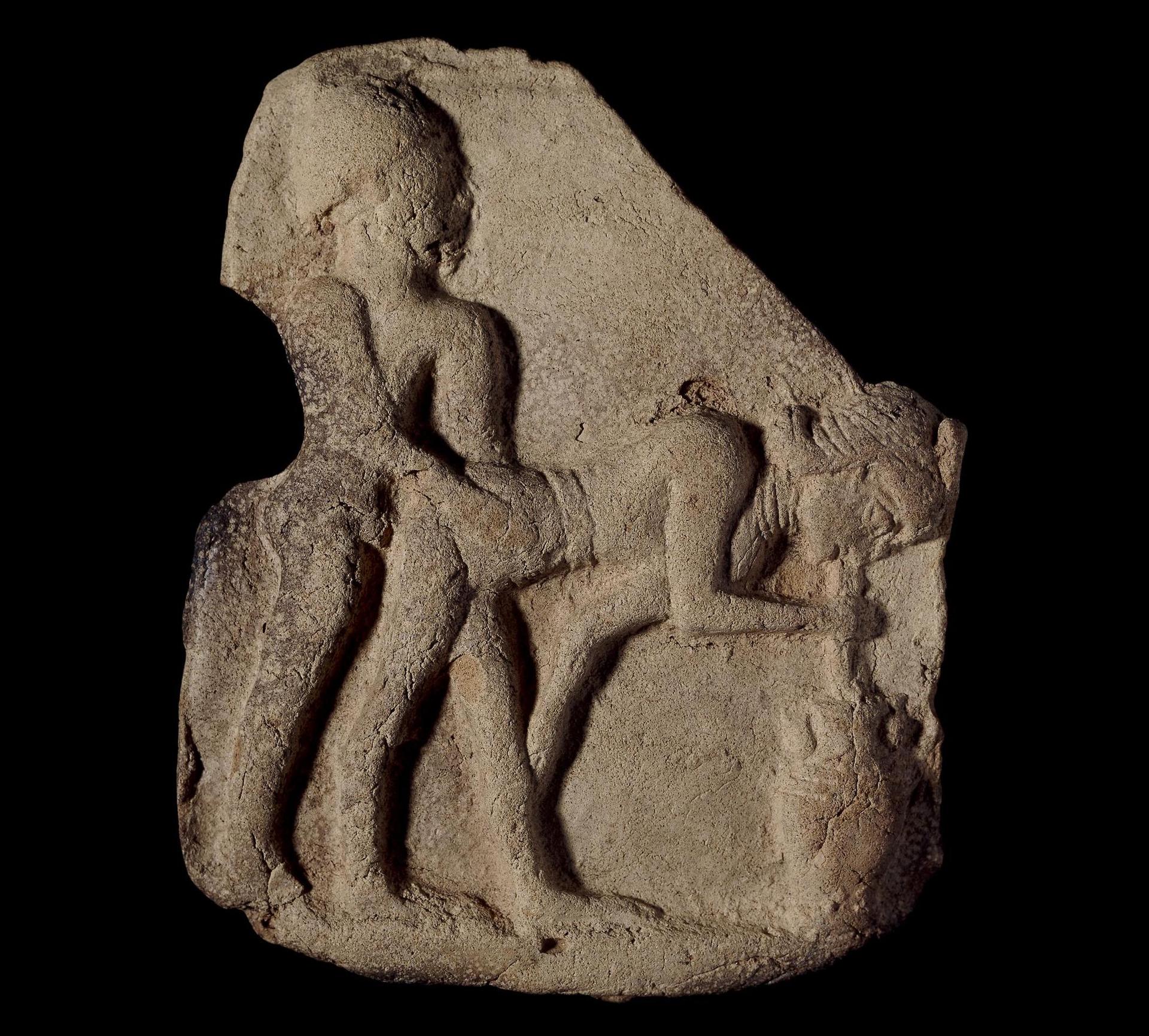 A stone carving of two people.