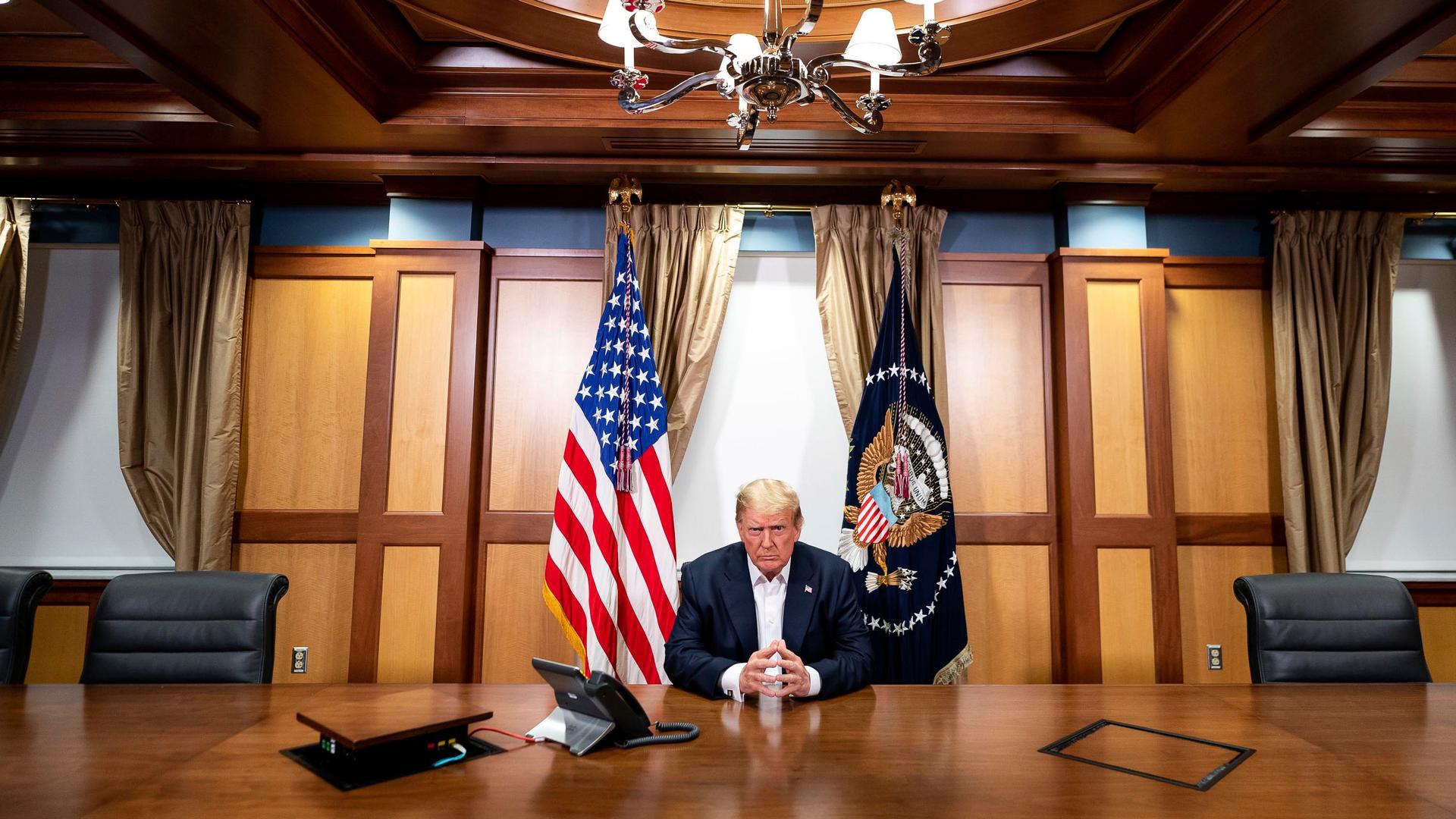 President Donald Trump listens during a phone call Oct. 4, 2020, in his conference room at Walter Reed National Military Medical Center in Bethesda, Maryland.