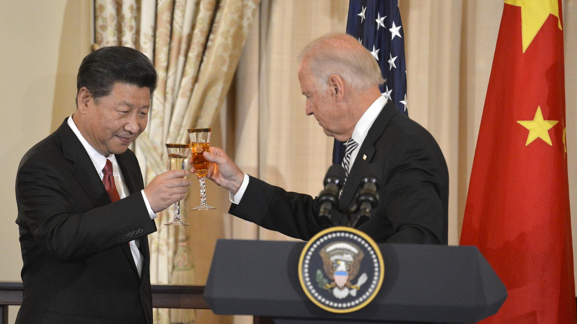 Chinese President Xi Jinping and then-Vice President Joe Biden raise their glasses in a toast during a luncheon at the State Department, in Washington, Sept. 25, 2015. 