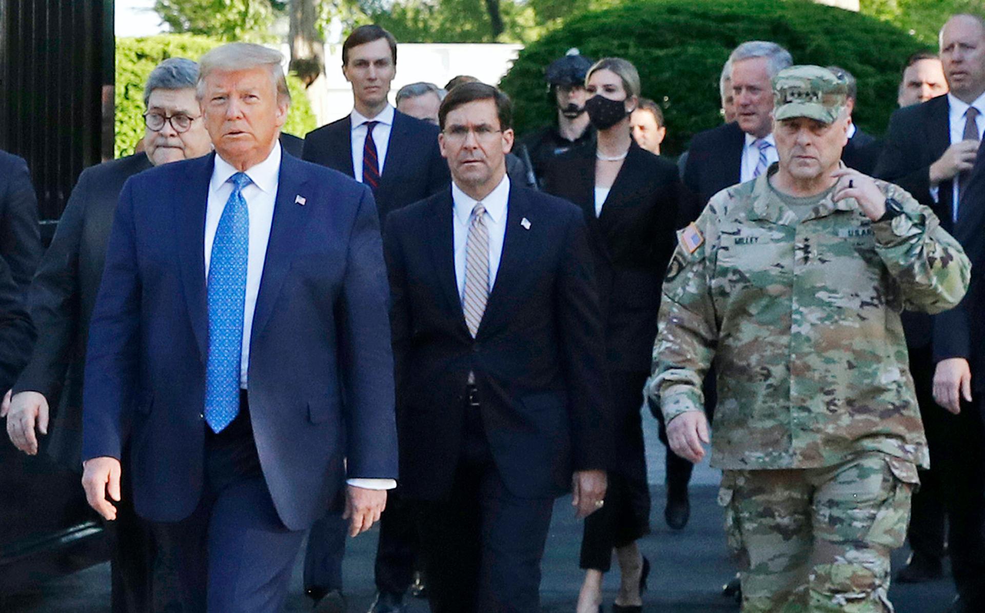 In this June 1 file photo, President Donald Trump departs the White House to visit outside St. John's Church. Walking behind Trump, at right, is Gen. Mark Milley, chairman of the Joint Chiefs of Staff.