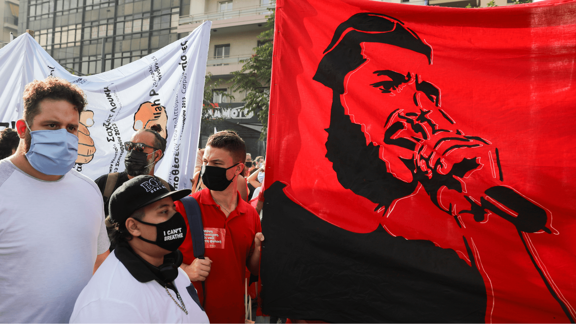 A bright red banner depicting anti-racist Greek rapper Pavlos Fyssas is seen, as demonstrators protest at the close of the trial for leaders and members of the far-right Golden Dawn, in Athens, Greece, Oct. 7, 2020.