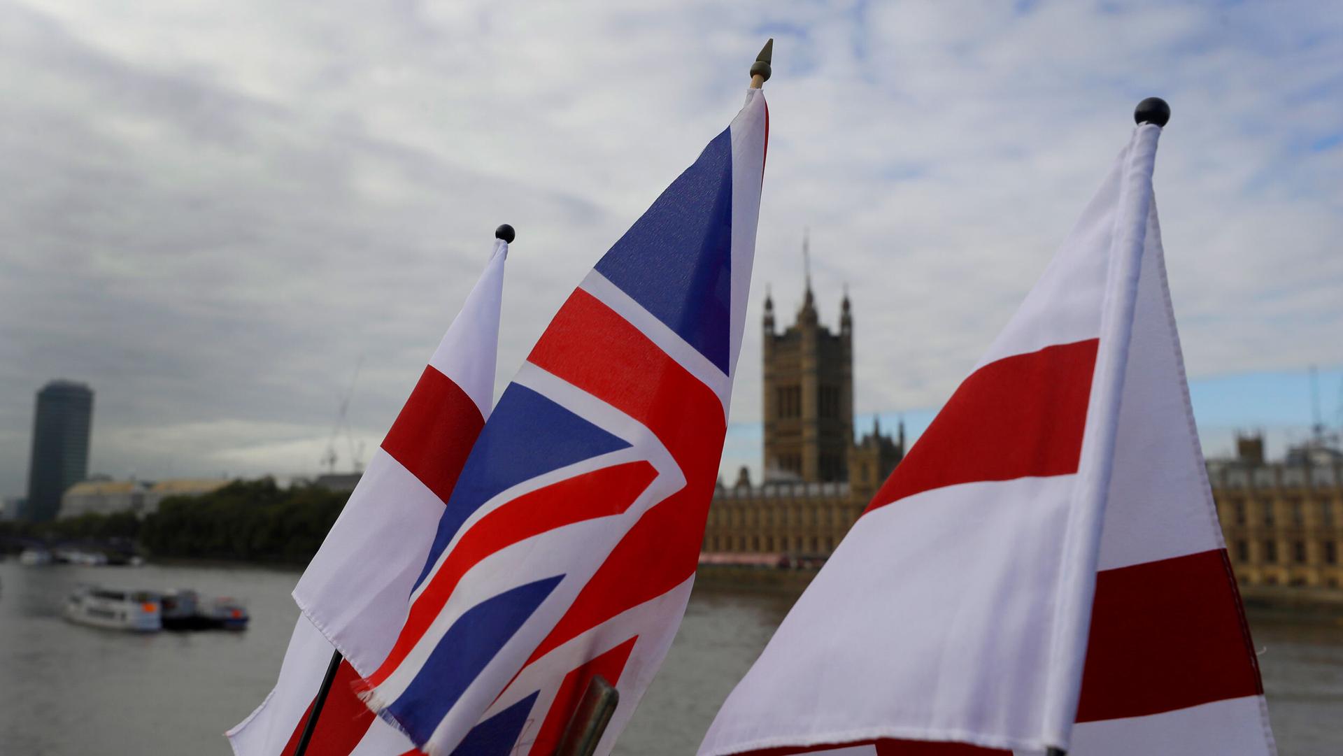 UK and England flags fly above a souvenir stand opposite Britain's Parliament in London, Oct. 16, 2020.