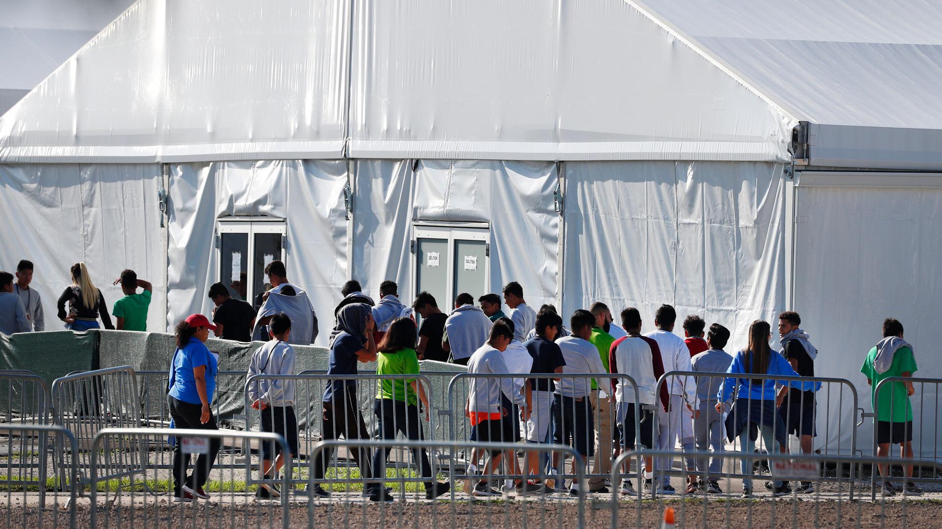 Children line up to enter a a temporary shelter in Florida, Feb. 2019.
