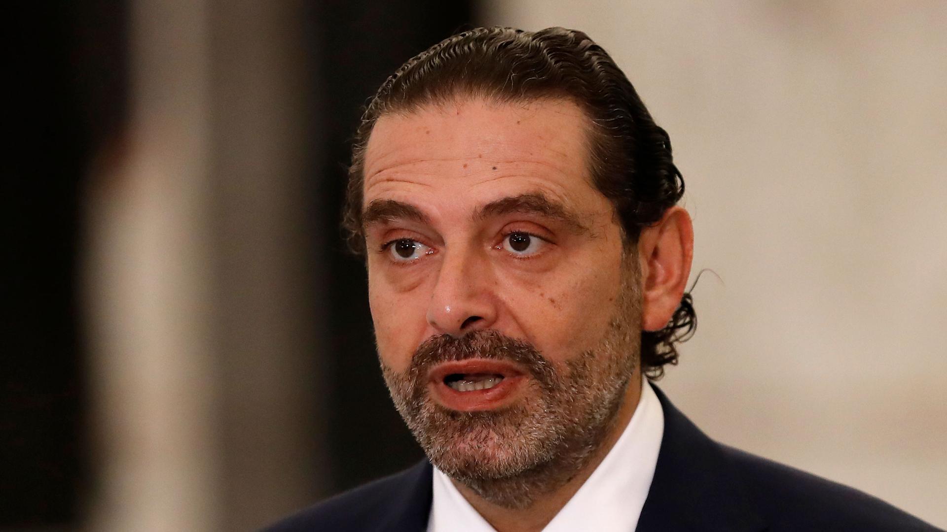 Lebanese Prime Minister-Designate Saad Hariri is show with his hair slicked back and wearing a dark suit.