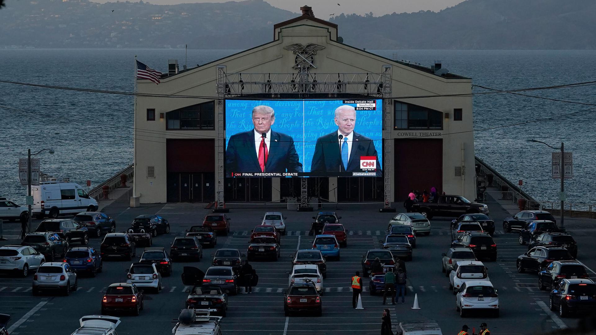 People watch from their vehicles as US President Donald Trump and Democratic presidential candidate former Vice President Joe Biden speak during a Presidential Debate Watch Party at Fort Mason Center in San Francisco, Oct. 22, 2020.