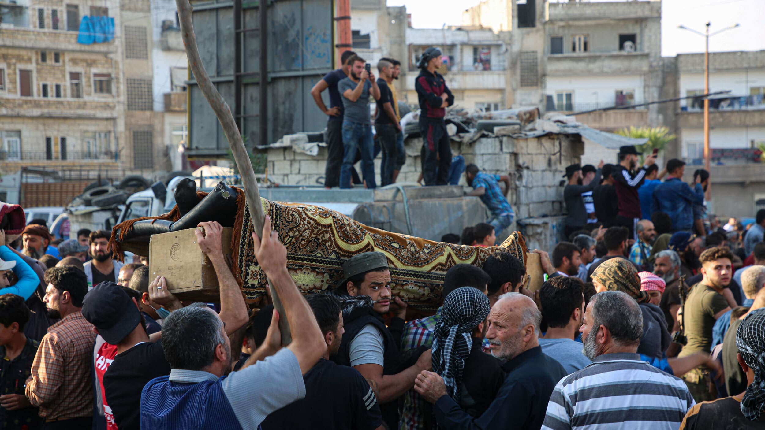 People attend funeral of fighters killed in an airstrike in the town of Idlib, Syria, Oct. 26, 2020.
