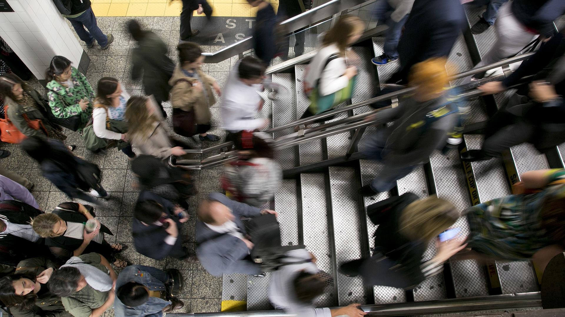 A crowd of people rushing in a subway station