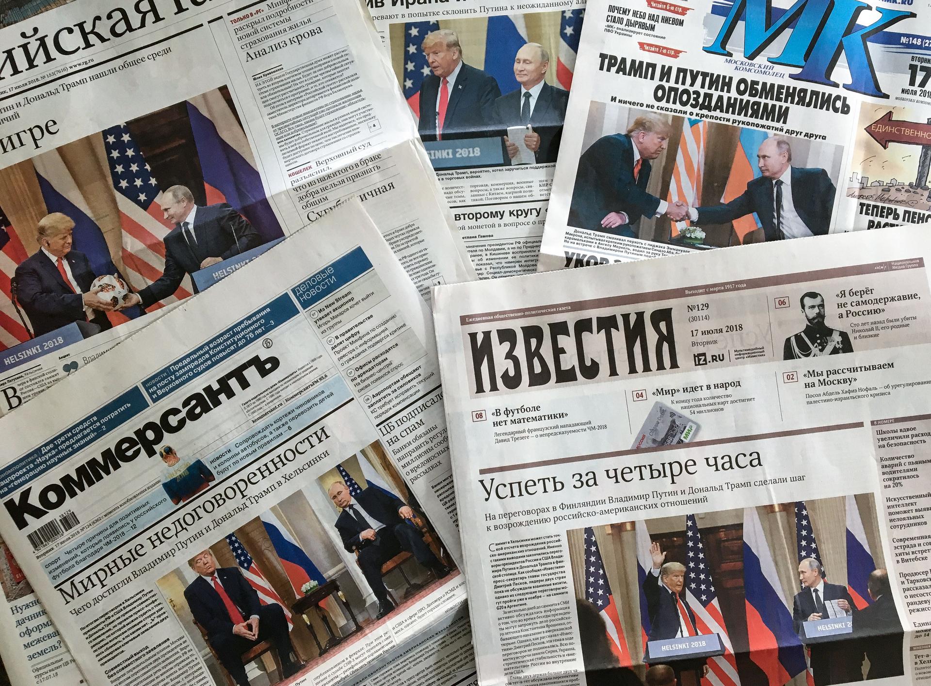 A stack of front pages from Russian newspapers depicting photos of Trump and Putin's friendly relationship.