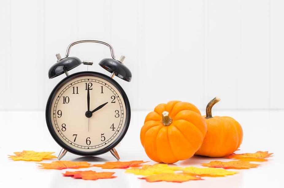 An alarm clock and a pumpkin