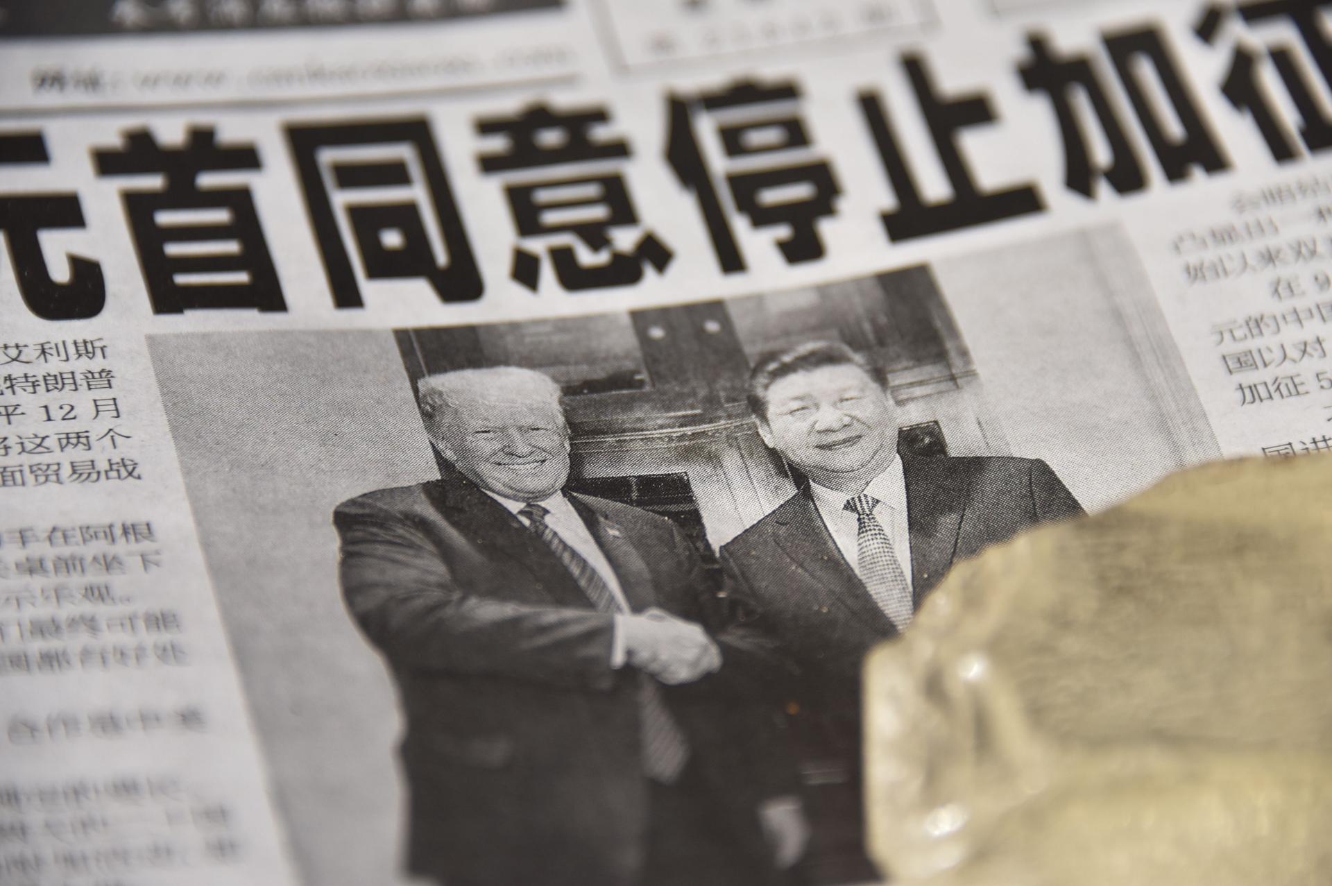 A Chinese newspaper displays an image of friendly presidents Donald Trump and Xi Jinping.