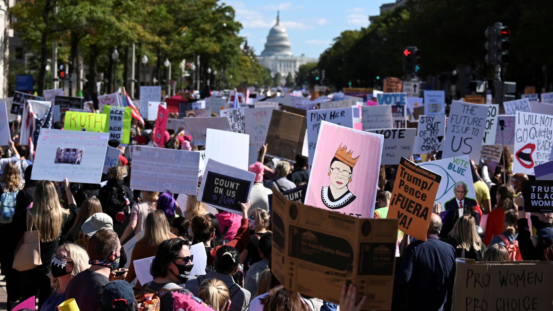 Women's March activists participate in a nationwide protest against US President Donald Trump's decision to fill the seat on the Supreme Court left by the passing of late Justice Ruth Bader Ginsburg before the 2020 election, in Washington, Oct. 17, 2020. 