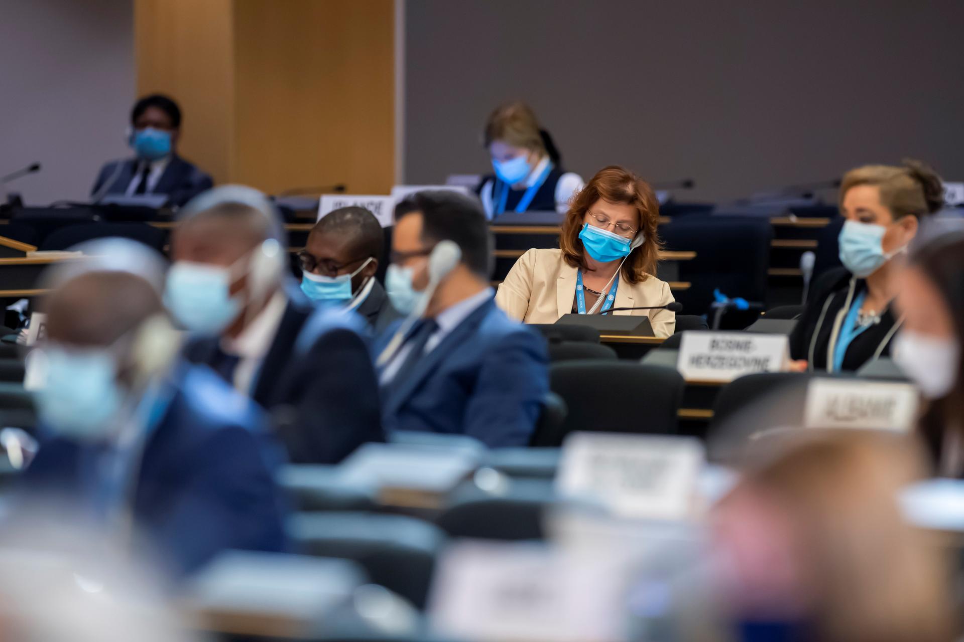 Delegates, wearing masks, listen to speeches during the 45th session of the Human Rights Council, at the European UN headquarters in Geneva, Sept. 14, 2020. 