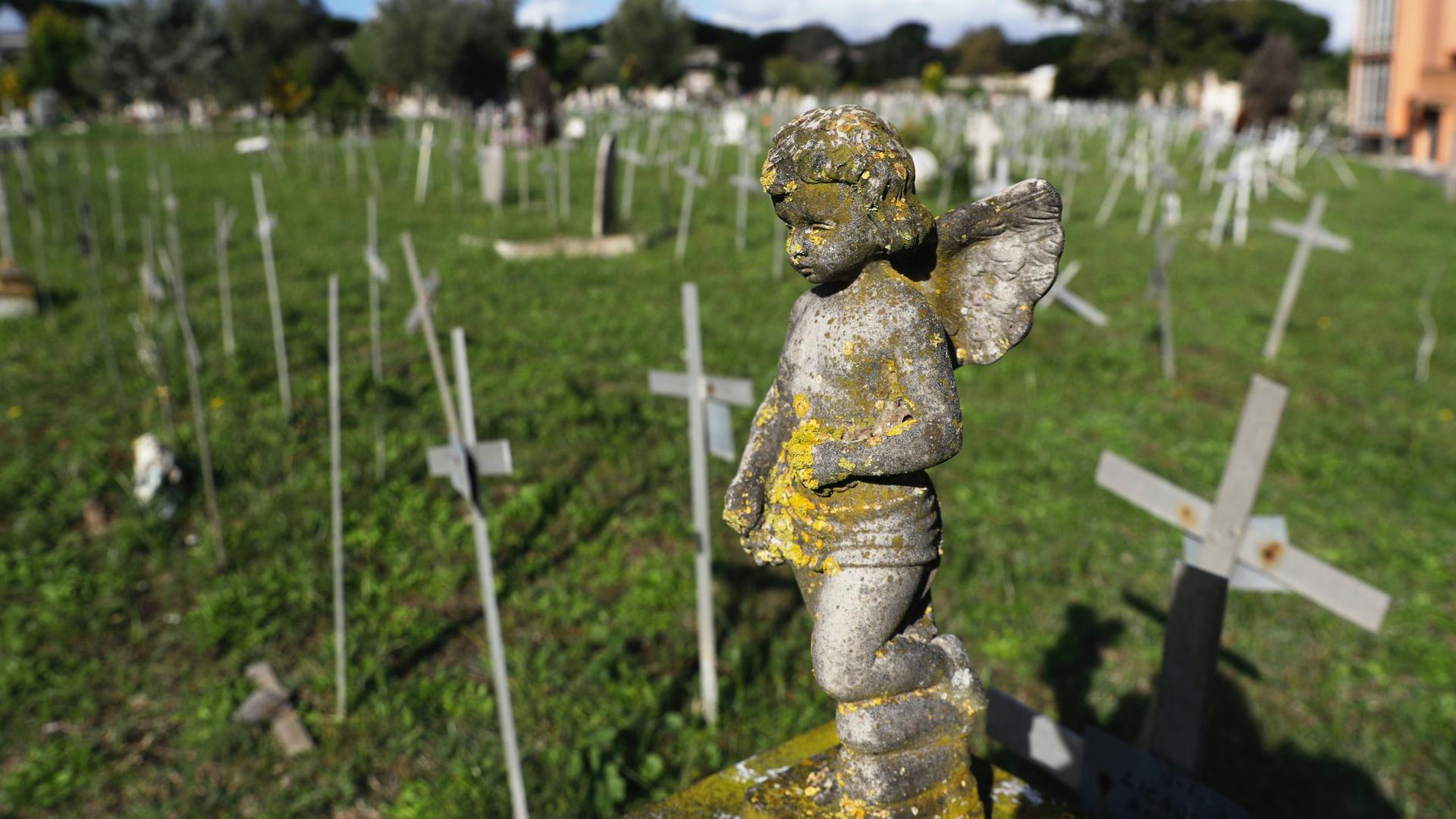 Crosses bearing tags with names are seen in a graveyard of the Flaminio Cemetery, in Rome, Italy, Oct. 16, 2020. 