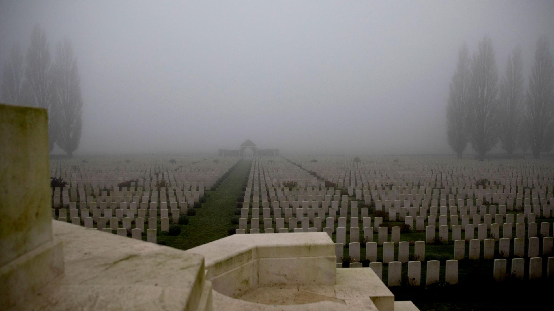 Dozens of rows of headstones are shown in rows at the Tyne Cot cemetery.