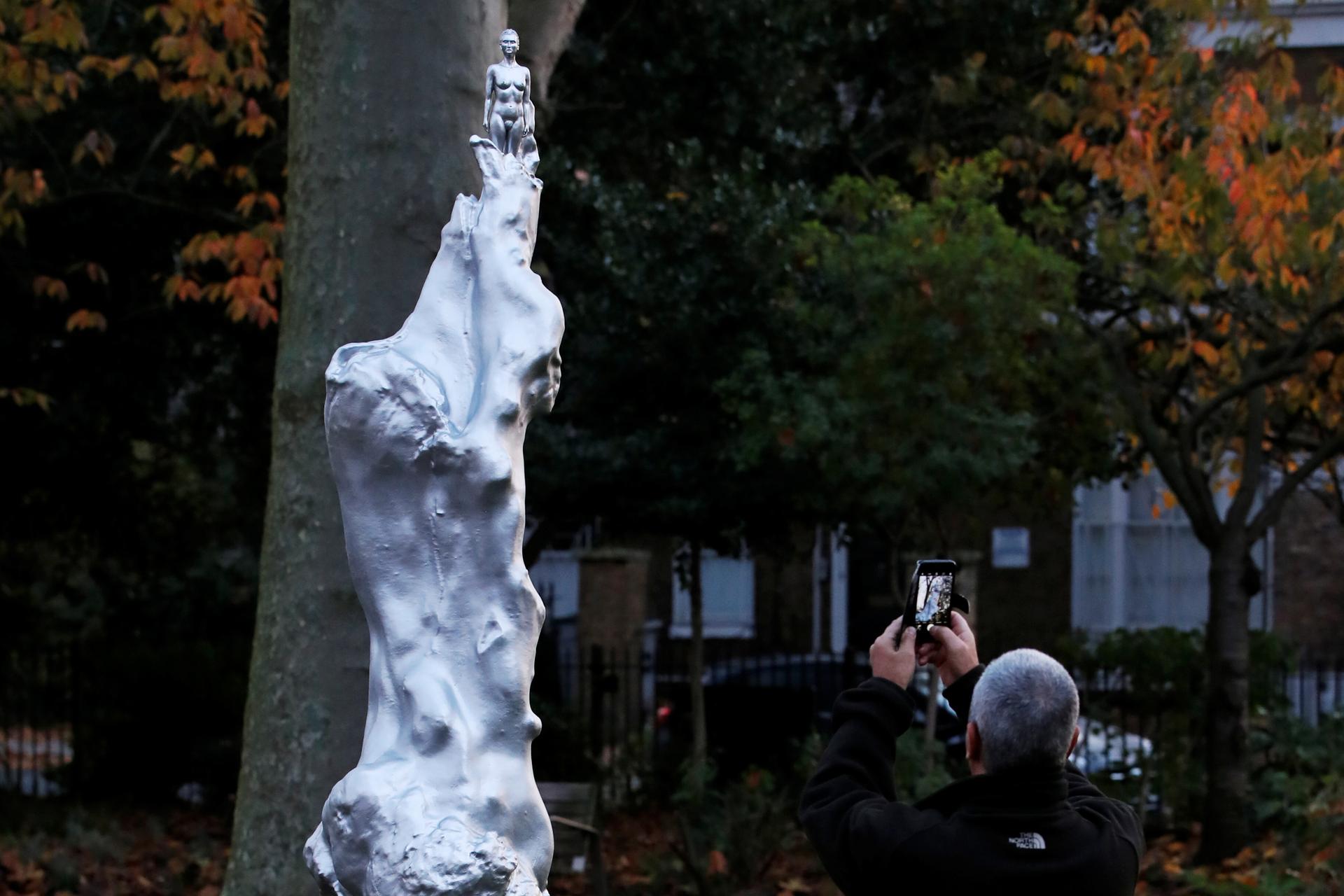 A person takes a photo of the Mary Wollstonecraft statue by artist Maggi Hambling in Newington Green, London, Britain, Nov. 11, 2020.