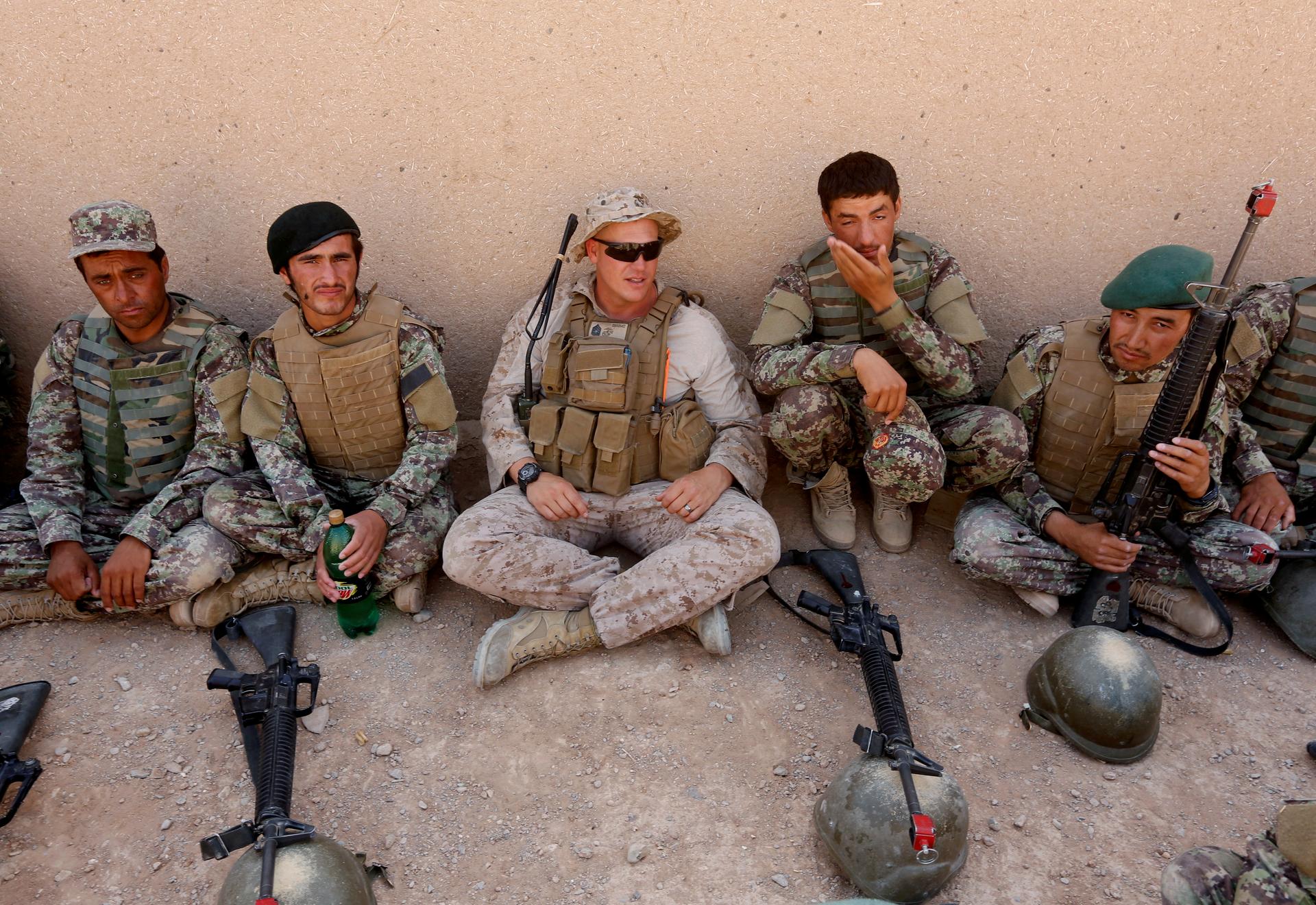 A US Marine (center) talks with Afghan National Army (ANA) soldiers during a training in Helmand province, Afghanistan, July 5, 2017.