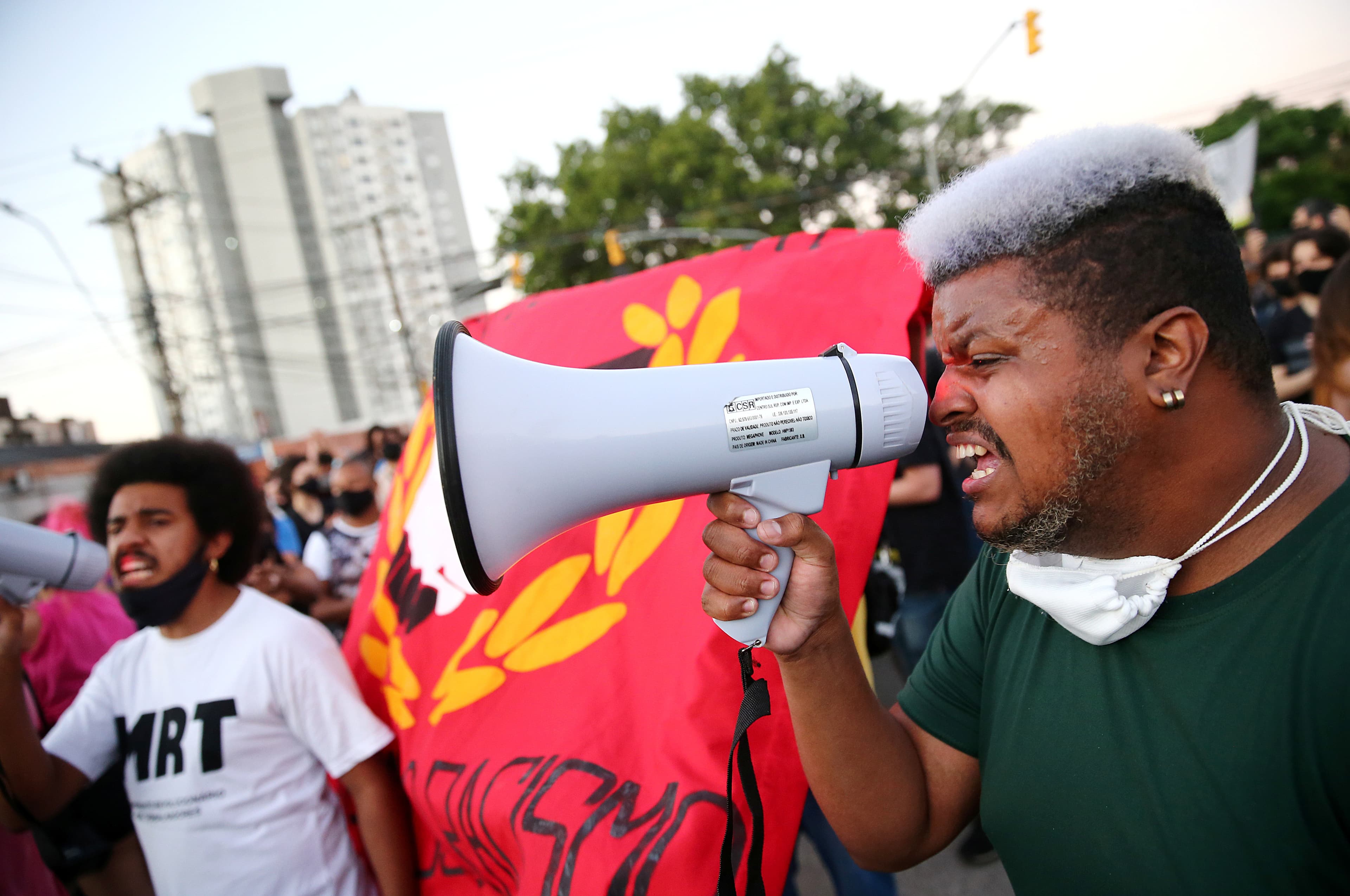 A demonstrator reacts during a protest against racism after João Alberto Silveira Freitas was beaten to death by security guards at a Carrefour supermarket in Porto Alegre, Brazil, Nov. 23, 2020.
