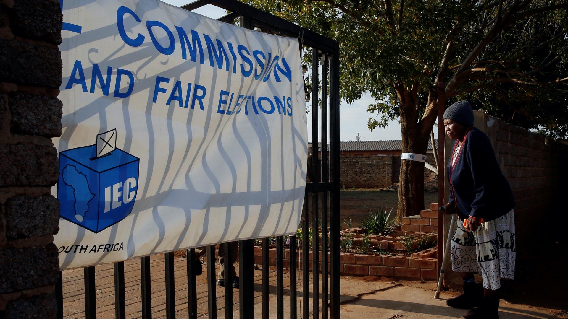 A voter arrives to cast her ballot at a polling station, during the South Africa's parliamentary and provincial elections.