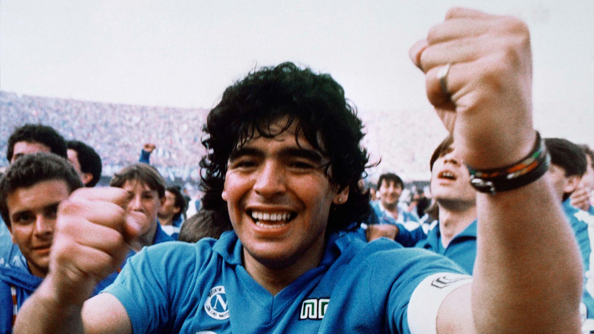 Argentine soccer superstar Diego Armando Maradona cheers after the Napoli team clinched its first Italian major league title in Naples, Italy, on May 10, 1987. 