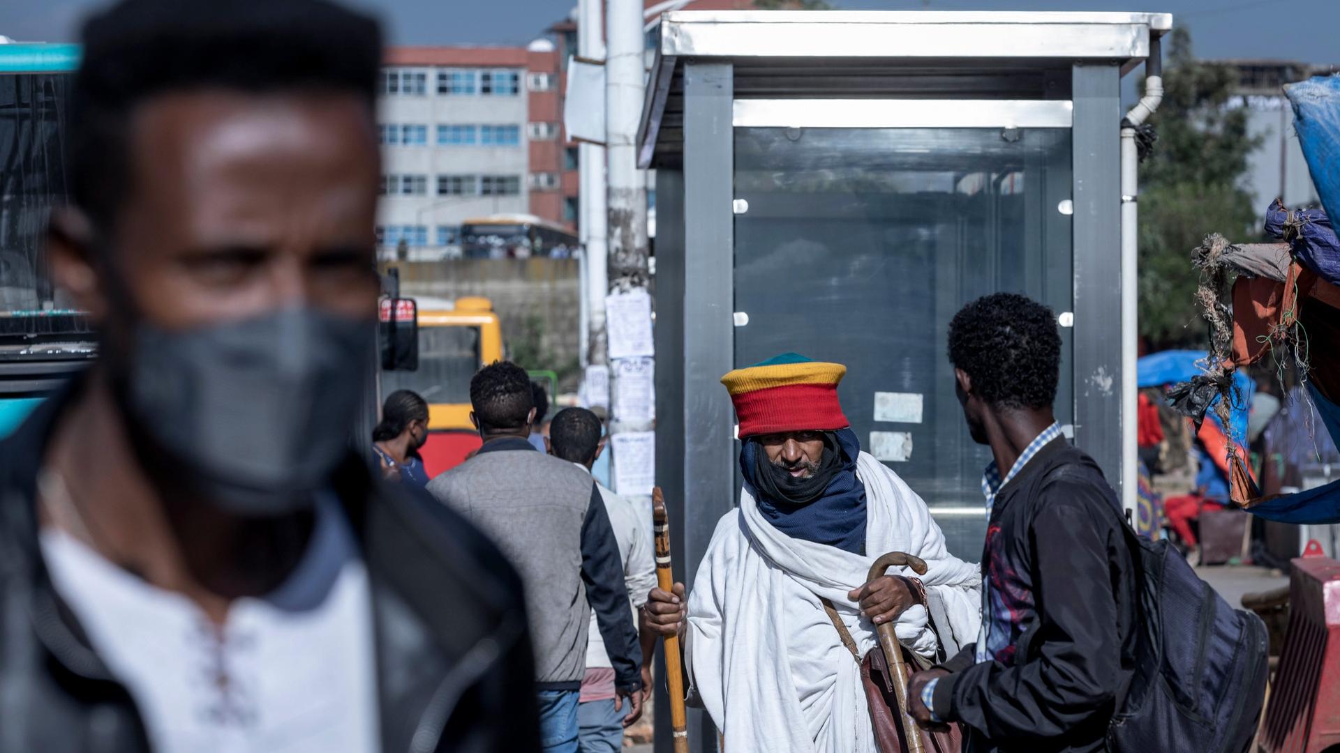 Passengers walk through a bus station in the capital Addis Ababa, Ethiopia, Nov. 6, 2020.
