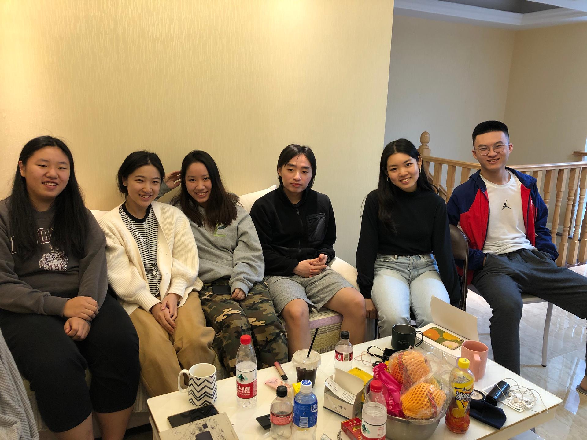 Emily Mao, second from left, joined a co-living community of students in Hangzhou, China, who are studying online — often overnight — at US and Canada-based colleges and universities.
